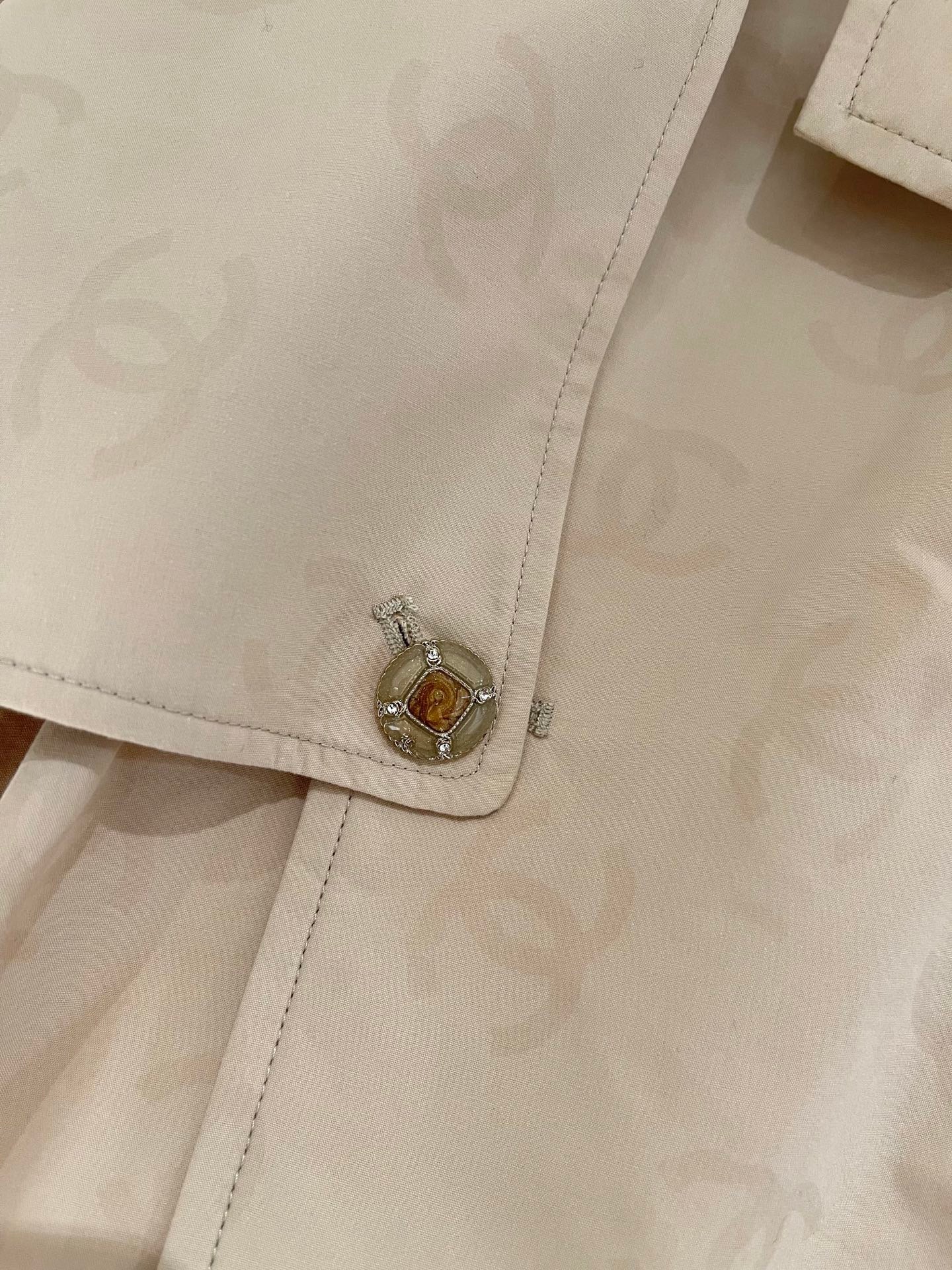 Chan's new short trench coat with subtle logo print