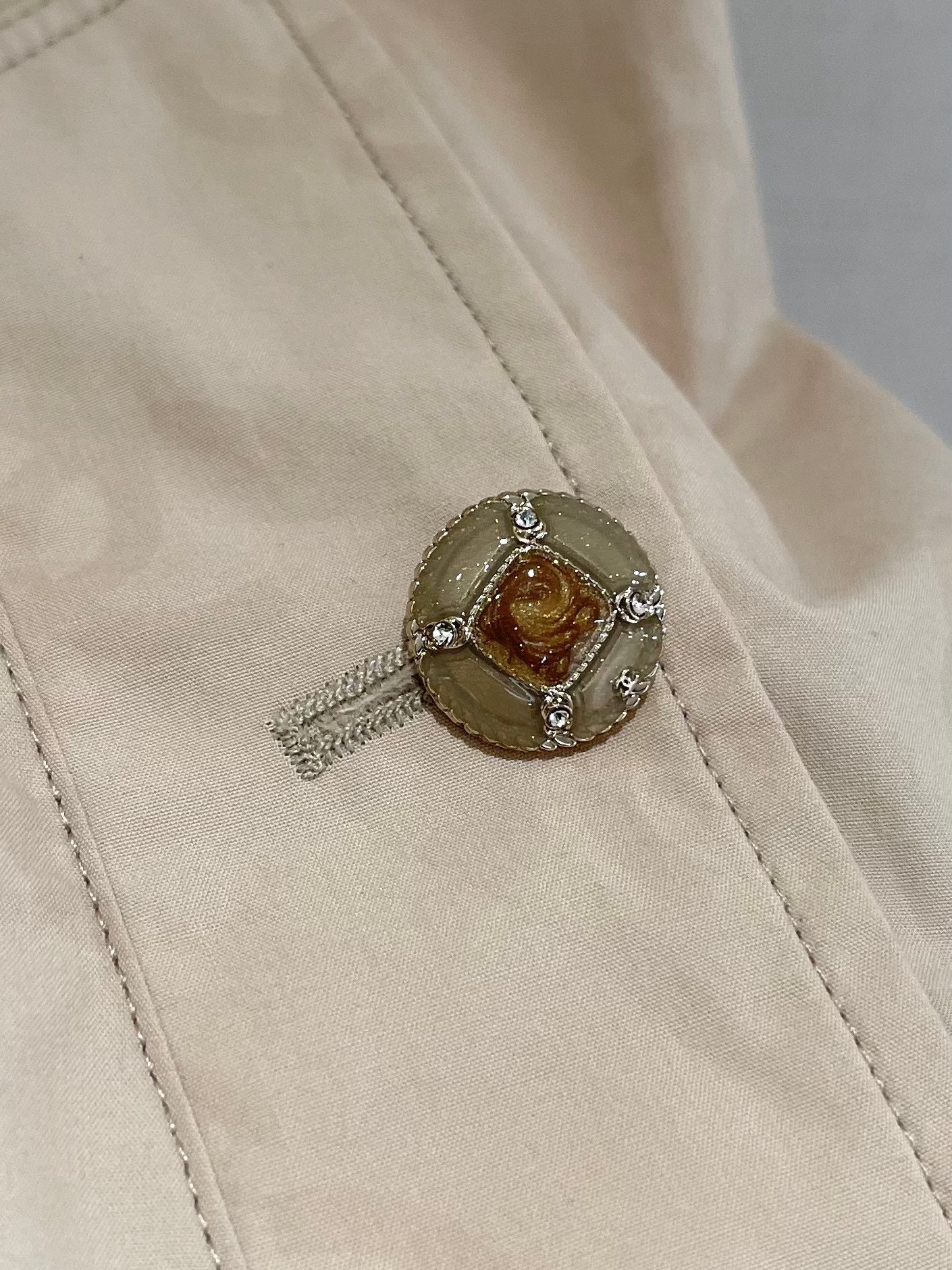 Chan's new short trench coat with subtle logo print