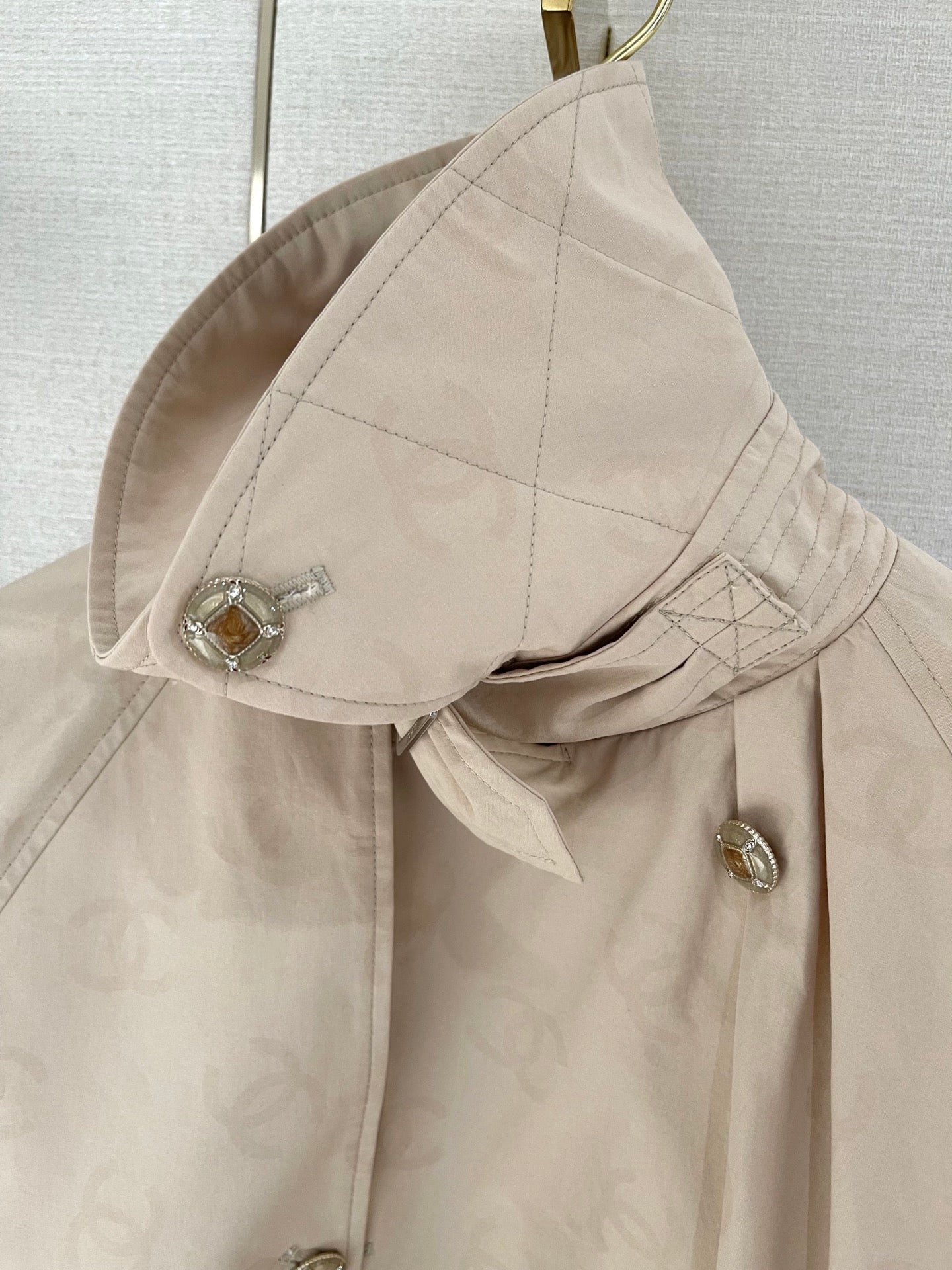 Chan's new short trench coat with subtle logo print